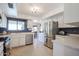 Bright kitchen features stainless steel appliances, white cabinetry, and tiled floor at 13232 W Ballad Dr, Sun City West, AZ 85375