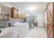 Convenient laundry area featuring a utility sink, washer, dryer, and extra storage space for efficiency at 13232 W Ballad Dr, Sun City West, AZ 85375