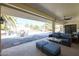 Relaxing covered patio area with plush seating, perfect for enjoying the outdoor oasis and beautiful pool view at 13232 W Ballad Dr, Sun City West, AZ 85375