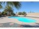 Backyard pool surrounded by desert landscaping and palm trees for a relaxing outdoor space at 13232 W Ballad Dr, Sun City West, AZ 85375