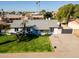 Aerial shot showcases a single-story home with a manicured lawn, blue door, and convenient driveway at 13446 N 18Th Ave, Phoenix, AZ 85029