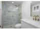 Bright, newly remodeled bathroom featuring a glass shower with gold fixtures and a modern vanity at 13446 N 18Th Ave, Phoenix, AZ 85029