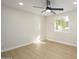 Neutral bedroom featuring wood-look flooring, recessed lights, and a bright window at 13446 N 18Th Ave, Phoenix, AZ 85029