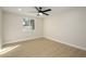 Neutral bedroom with a window letting in natural light, plus a ceiling fan at 13446 N 18Th Ave, Phoenix, AZ 85029