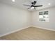 Bright bedroom featuring a ceiling fan, wood-look flooring, and a window at 13446 N 18Th Ave, Phoenix, AZ 85029