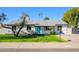 Charming single-story home with a vibrant blue door, well-manicured lawn, and mature landscaping at 13446 N 18Th Ave, Phoenix, AZ 85029