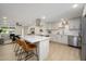 Modern kitchen with white countertops, stainless steel appliances and breakfast bar with three chairs at 13446 N 18Th Ave, Phoenix, AZ 85029