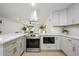 Kitchen featuring stainless steel appliances, marble countertops, and white cabinets at 13446 N 18Th Ave, Phoenix, AZ 85029