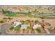 Expansive aerial view showcasing houses near a golf course with serene water features and lush greenery at 14264 S Baniff Ln, Arizona City, AZ 85123