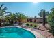 Backyard pool area features desert landscaping, palm trees, patio furniture, and a desert architectural style home at 14264 S Baniff Ln, Arizona City, AZ 85123