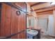 Rustic bathroom with a unique sink, and themed door at 14264 S Baniff Ln, Arizona City, AZ 85123