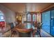 Elegant dining room features a chandelier, wood table, china cabinet, and access to the outdoor living space at 14264 S Baniff Ln, Arizona City, AZ 85123