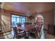 Formal dining area with wood table, chandelier lighting, and outdoor views at 14264 S Baniff Ln, Arizona City, AZ 85123