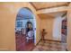 Inviting foyer with arched doorway, classic furnishings, and decorative tile flooring at 14264 S Baniff Ln, Arizona City, AZ 85123