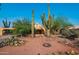 Stunning desert home with mature landscaping and a unique stone-lined driveway, complete with saguaro cacti at 14264 S Baniff Ln, Arizona City, AZ 85123