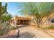 Charming desert home with mature landscaping and a unique stone-lined driveway, complete with saguaro cacti at 14264 S Baniff Ln, Arizona City, AZ 85123