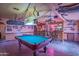 Fantastic game room with a pool table, a bar, and creative lighting at 14264 S Baniff Ln, Arizona City, AZ 85123