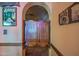 Hallway with arched doorway and swinging doors at 14264 S Baniff Ln, Arizona City, AZ 85123