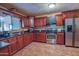 Updated kitchen with cherry wood cabinetry, granite countertops, and stainless steel appliances at 14264 S Baniff Ln, Arizona City, AZ 85123