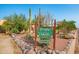 Eye-catching sign with 'CASA DE LEVY' and address number, surrounded by mature desert landscaping and river rock at 14264 S Baniff Ln, Arizona City, AZ 85123