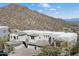 Aerial view of a modern home set against a backdrop of desert and mountain at 14850 E Grandview Dr # 226, Fountain Hills, AZ 85268