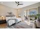 Bright bedroom featuring light wood floors, a decorative rug, and access to the private balcony at 14850 E Grandview Dr # 226, Fountain Hills, AZ 85268