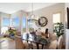 Chic dining room featuring a modern chandelier, sleek black table, and stunning views from large windows at 14850 E Grandview Dr # 226, Fountain Hills, AZ 85268