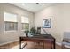 Stylish home office with hardwood floors, a modern desk setup, and natural light from two windows at 14850 E Grandview Dr # 226, Fountain Hills, AZ 85268