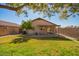 Large, grassy backyard with a covered patio, perfect for outdoor entertaining and relaxation at 14946 W Caribbean Ln, Surprise, AZ 85379