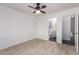 This bedroom features neutral paint, tile floors, and a ceiling fan at 14946 W Caribbean Ln, Surprise, AZ 85379