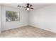 Clean bedroom featuring tile floors, a ceiling fan, and a window at 14946 W Caribbean Ln, Surprise, AZ 85379