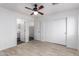 This bedroom has tile floors, a ceiling fan, and a large closet at 14946 W Caribbean Ln, Surprise, AZ 85379