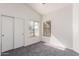 The neutral bedroom features carpet, two large windows, and a closet at 14946 W Caribbean Ln, Surprise, AZ 85379