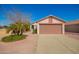 Charming single-story home with a well-manicured yard and a two-car garage at 14946 W Caribbean Ln, Surprise, AZ 85379