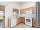 Well-lit kitchen with tile floors, stainless steel appliances, and ample cabinet space at 14946 W Caribbean Ln, Surprise, AZ 85379