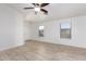 Spacious living area with tile flooring, natural light, and a modern ceiling fan at 14946 W Caribbean Ln, Surprise, AZ 85379