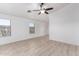 Bright living area with tile floors, ceiling fan, and large windows at 14946 W Caribbean Ln, Surprise, AZ 85379