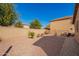 Backyard with low maintenance desert landscaping and block fence for privacy at 16150 W Hope Dr, Surprise, AZ 85379