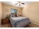 Inviting bedroom featuring a comfortable bed, window and ceiling fan at 16150 W Hope Dr, Surprise, AZ 85379