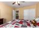 Cozy bedroom featuring a comfortable bed, ceiling fan, and closet at 16150 W Hope Dr, Surprise, AZ 85379