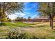 Lush community park featuring green spaces, mature trees, walkways, and nearby residential homes at 16150 W Hope Dr, Surprise, AZ 85379