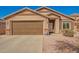 Charming single-story home showcasing a well-kept lawn, desert landscape, and a two-car garage at 16150 W Hope Dr, Surprise, AZ 85379