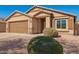 A single-story home with a 2 car garage and desert landscaping in the front yard at 16150 W Hope Dr, Surprise, AZ 85379