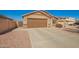 Single-level home with a desert rock yard, wide driveway, and a two-car garage at 16150 W Hope Dr, Surprise, AZ 85379