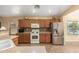 Bright kitchen featuring wood cabinets, stainless steel refrigerator, and a neutral color scheme at 16150 W Hope Dr, Surprise, AZ 85379