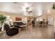 Inviting living room featuring tile floors, ceiling fan, and seamless flow to the kitchen with barstool seating at 16150 W Hope Dr, Surprise, AZ 85379