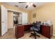 Spacious office with a desk, chair, and view of the backyard at 16150 W Hope Dr, Surprise, AZ 85379