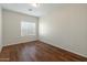 Bright bedroom with laminate floors, large window, and neutral color at 16219 W Woodlands Ave, Goodyear, AZ 85338