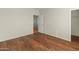 Neutral bedroom with laminate floors, a closet and a door at 16219 W Woodlands Ave, Goodyear, AZ 85338