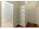 Walk-in closet with wire shelving and access to the bathroom at 16219 W Woodlands Ave, Goodyear, AZ 85338